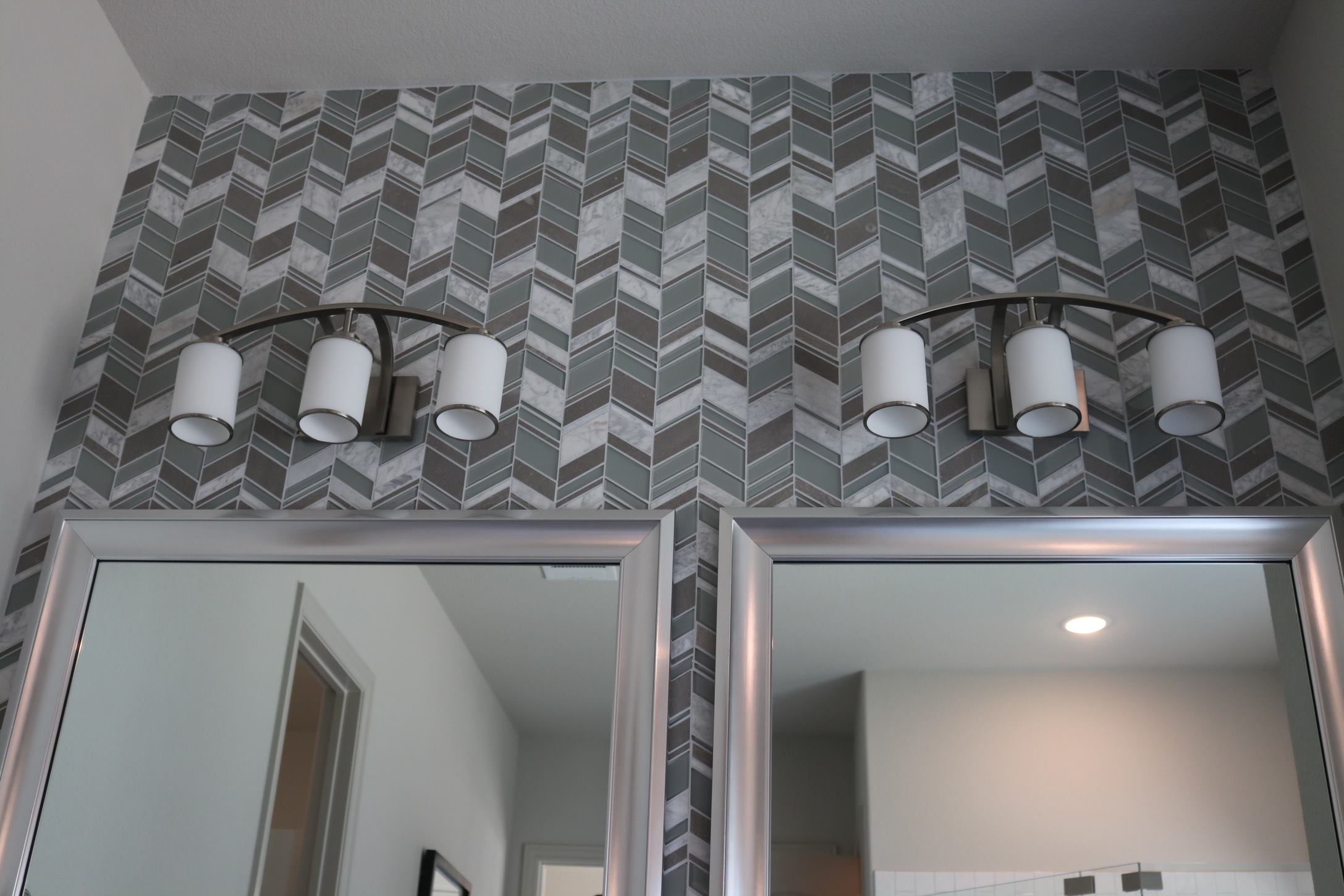 3 light brushed nickel vanity light over mirror